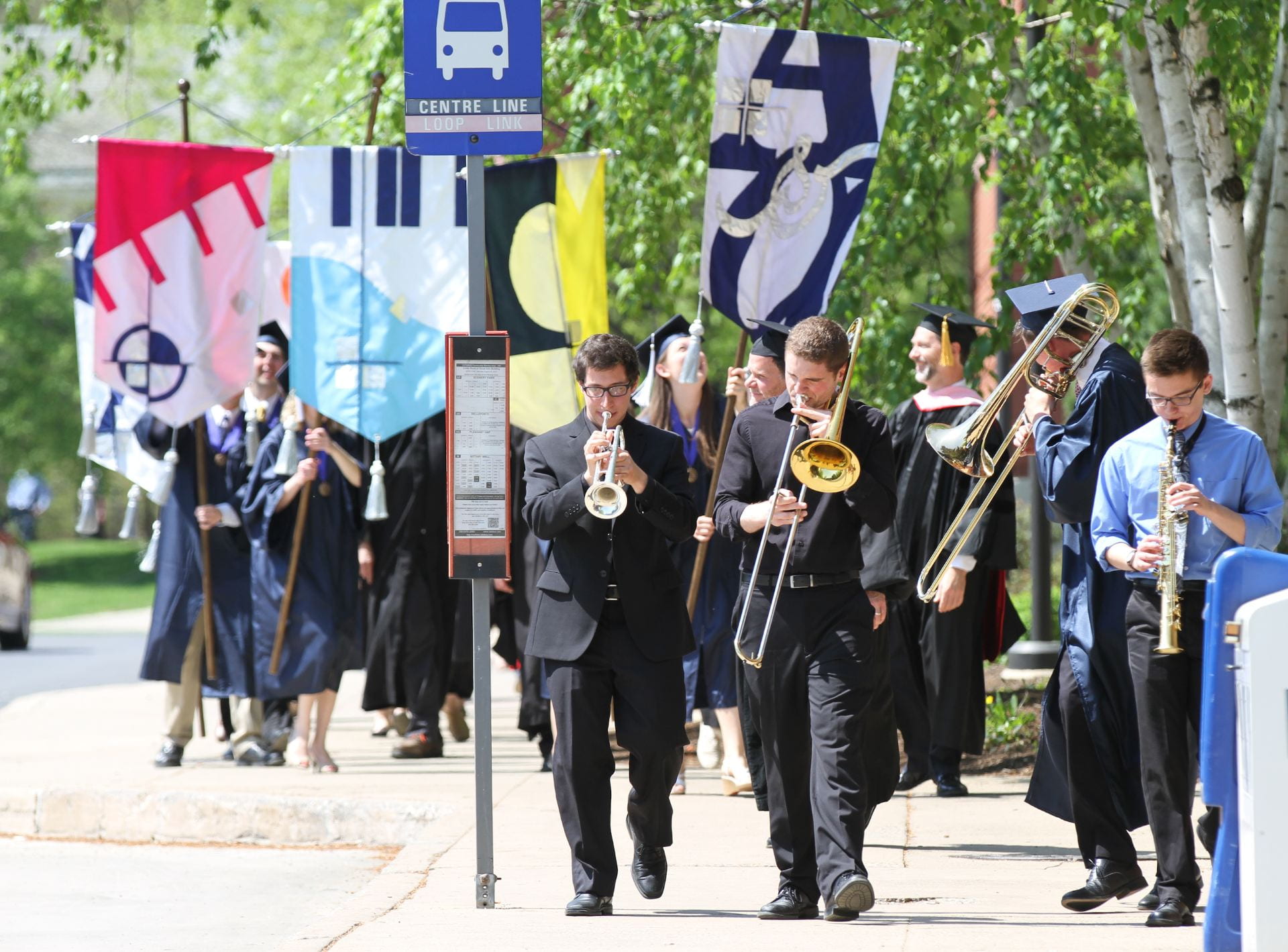 A procession of Jazz Concert students performing during commencement.