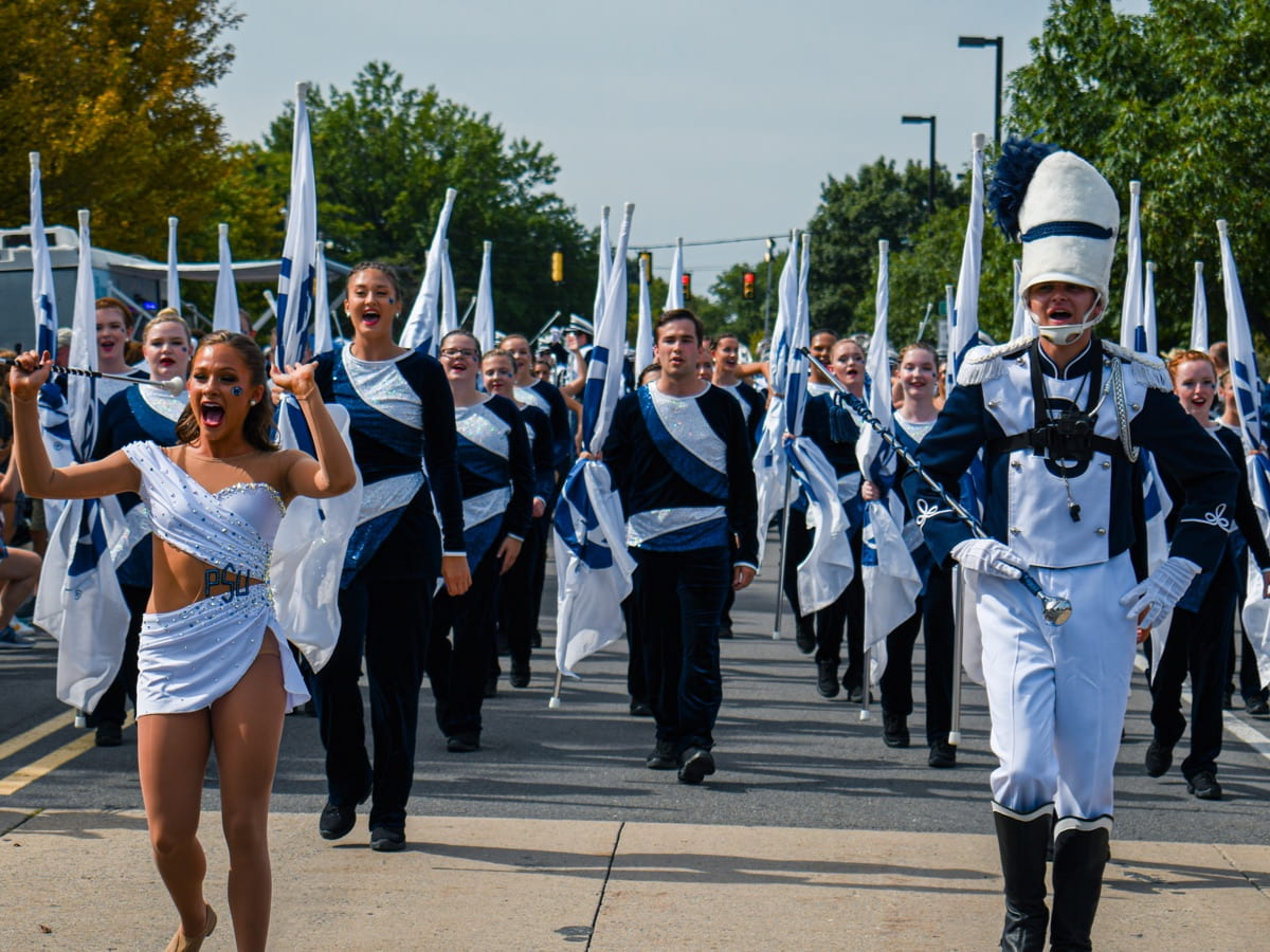 Blue Band Silks marching in perfect rows in an on-street parade. 